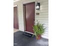 Condo exterior featuring a welcoming entryway with a welcome mat and potted fern at 503 Gooseneck Drive # B4, Cary, NC 27513