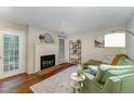 The living room has a fireplace, green couch, and a bookcase with books, plants, and decorations at 503 Gooseneck Drive # B4, Cary, NC 27513