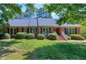 Classic brick home with well-maintained lawn and landscaping at 7204 Bellweather N Ct, Raleigh, NC 27615