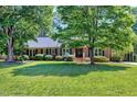 Well-maintained brick home with a beautiful front yard and mature trees at 7204 Bellweather N Ct, Raleigh, NC 27615