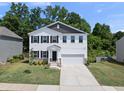 Charming two-story home with a well-manicured lawn and a two-car garage at 77 Rolling Creek Cir, Clayton, NC 27520
