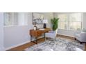 Bright home office featuring a wooden desk, stylish chair, and natural light at 802 Wakehurst Dr, Cary, NC 27519
