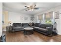 Inviting living room with hardwood floors, sectional sofa, ceiling fan, and plenty of natural light at 901 Currin Perry Rd, Zebulon, NC 27597