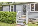 Welcoming front porch with classic details and well-maintained landscaping at 909 Goodwin Rd, Durham, NC 27712