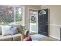 Bright living room with large window, hardwood floors and cozy decor at 909 Goodwin Rd, Durham, NC 27712