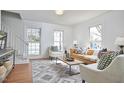 Bright living room with hardwood floors, a patterned rug, and an abundance of natural light at 913 Washington St, Durham, NC 27701