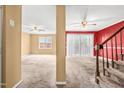 Spacious living room with carpet flooring, ceiling fans, and a sliding door to the outdoor area at 919 Lexington Ct, Cary, NC 27511