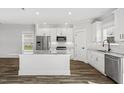 Open-concept kitchen with stainless steel appliances, granite countertops, and a functional kitchen island at 1009 Rhino Bnd, Oxford, NC 27565