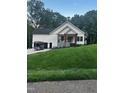 Inviting two-story home with a well-manicured lawn and covered front porch at 101 Cochise Cv, Louisburg, NC 27549