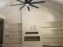 Bright open living room with tall vaulted ceilings and a fireplace with built in shelving at 101 Cochise Cv, Louisburg, NC 27549