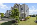 Well-maintained gray townhouse with landscaped front yard and manicured lawn at 1011 Canary Pepper Dr, Durham, NC 27713