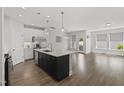 Open-concept kitchen with an island and stainless steel appliances at 1011 Canary Pepper Dr, Durham, NC 27713
