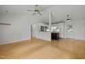 Spacious living room with ceiling fan, hardwood floors, and an open view into the kitchen at 1040 Mills St, Raleigh, NC 27608