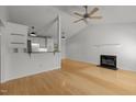 Open floor plan featuring hardwood floors, fireplace, and a ceiling fan for comfortable living at 1040 Mills St, Raleigh, NC 27608