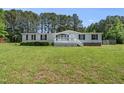 Charming one-story home with a white porch, complimented by a spacious lawn and bordered by trees at 109 Winding Creek Dr, Youngsville, NC 27596
