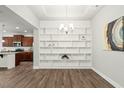 Open concept dining area with built-in shelving and view of the kitchen at 11 Woodwater Cir, Lillington, NC 27546