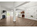 Open-concept living area with fireplace, hardwood floors, and view of kitchen and dining at 11 Woodwater Cir, Lillington, NC 27546