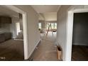 Bright hallway leading to open living space with hardwood floors and neutral paint at 112 Royal Ave, Selma, NC 27576