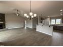 A view of the open-concept living space, featuring a fireplace and views to the kitchen at 112 Royal Ave, Selma, NC 27576
