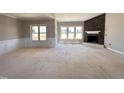 Inviting living room with a stone fireplace and bright windows, perfect for entertaining guests at 112 Royal Ave, Selma, NC 27576