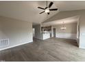Spacious living room with vaulted ceiling, ceiling fan, and wood-look flooring at 112 Royal Ave, Selma, NC 27576