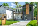 An eye-catching two-story home with unique siding, a two-car garage, and manicured landscaping at 1124 Upchurch St, Raleigh, NC 27610