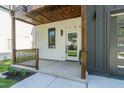 Charming front porch featuring wood trim and a covered entryway. Address '1124' prominently displayed at 1124 Upchurch St, Raleigh, NC 27610