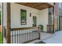 Inviting front porch with wood accents and a covered entryway. Address '1124' clearly displayed at 1124 Upchurch St, Raleigh, NC 27610