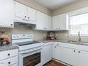 Bright kitchen featuring white cabinets, granite counters, and modern appliances at 113 Weatherstone Dr # B, Chapel Hill, NC 27514