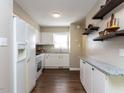 Eat-in kitchen featuring white appliances and cabinets, granite countertops, and wood flooring at 113 Weatherstone Dr # B, Chapel Hill, NC 27514