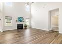 Bright living room with a soaring ceiling, modern fireplace, and abundant natural light at `120 Red Hawk Pl, Smithfield, NC 27577