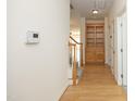 Hallway featuring hardwood floors, staircase, and a built-in cabinet at 12306 Mossgreen St, Raleigh, NC 27614