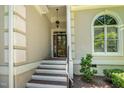 Elegant front entrance with brick steps, decorative columns, and a glass-paneled door at 12733 Pamplona Dr, Wake Forest, NC 27587