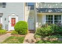 Charming townhome with manicured lawn and colorful flowerbeds enhancing its curb appeal at 1316 Garden Crest Cir, Raleigh, NC 27609