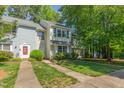 Charming townhome with manicured lawn and mature trees enhancing its curb appeal at 1316 Garden Crest Cir, Raleigh, NC 27609