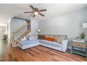Spacious living room with hardwood floors, cozy seating, and a ceiling fan at 1316 Garden Crest Cir, Raleigh, NC 27609