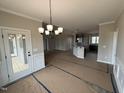 Elegant dining area showcasing modern lighting and an open layout connected to the kitchen and living spaces at 134 Royal Ave, Selma, NC 27576