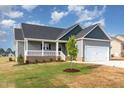 Charming single-Gathering home featuring a two-car garage and a well-manicured lawn at 134 Royal Ave, Selma, NC 27576