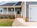 Inviting front entrance with a covered porch and brick detailing at 134 Royal Ave, Selma, NC 27576