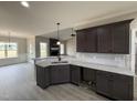 A kitchen with granite countertops, pendant lighting, and easy access to the living and dining areas at 134 Royal Ave, Selma, NC 27576