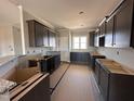 Kitchen featuring wooden cabinets, stainless sink, and granite countertops at 134 Royal Ave, Selma, NC 27576