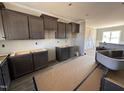 Kitchen featuring wooden cabinets, stainless sink, and granite countertops at 134 Royal Ave, Selma, NC 27576