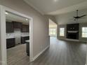 An open floor plan features luxury vinyl plank flooring, and a stunning fireplace with stone surround at 134 Royal Ave, Selma, NC 27576