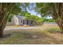 Home showcasing a large lot, mature trees, and a screened in front porch at 1429 Hudson Ave, Durham, NC 27705