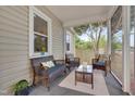 Comfortable seating area on a screened-in porch, perfect for relaxing and enjoying the outdoors at 1429 Hudson Ave, Durham, NC 27705
