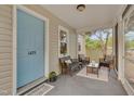 Inviting screened-in front porch offering comfortable seating and a relaxing outdoor space at 1429 Hudson Ave, Durham, NC 27705
