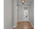 Bright hallway with wood floors and natural light streaming through the front door, creating a warm entry at 1641 Silo Ridge Dr, Wake Forest, NC 27587