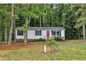 Charming single-story home featuring white siding, black shutters, and a welcoming red front door at 196 Marlin Ln, Smithfield, NC 27577