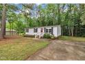 Charming single-story home featuring white siding, black shutters, and a welcoming red front door at 196 Marlin Ln, Smithfield, NC 27577