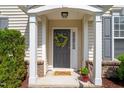 Welcoming front porch features decorative wreath, 'Hello Sunshine' mat, and seasonal decor at 207 Bell Tower Way, Morrisville, NC 27560